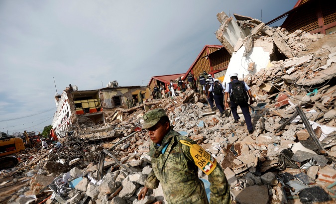 Soldiers work to remove the debris of a house destroyed in Juchitan, Mexico, September 8, 2017
