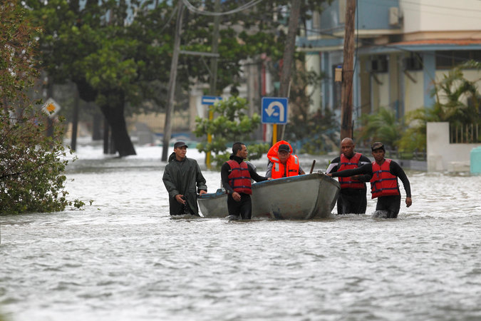 A man is rescued from a flooded neighbourhood