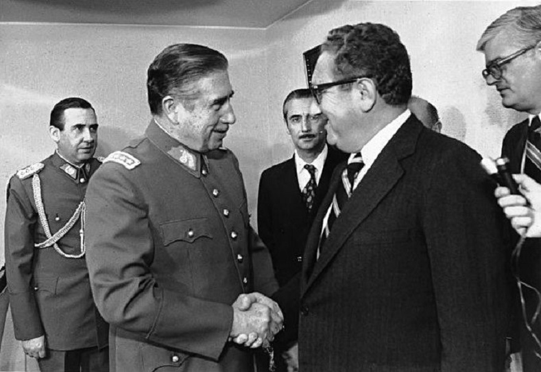 U.S. Secretary of State Henry Kissinger meets Pinochet in 1976. The U.S. role in the coup is well-documented and condemned.