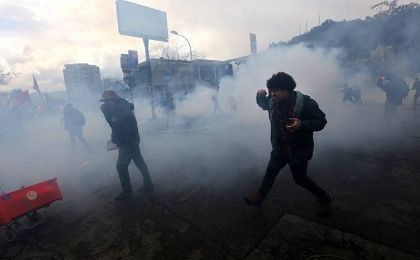 Police fire teargas at Chileans observing the anniversary of the Pinochet coup.