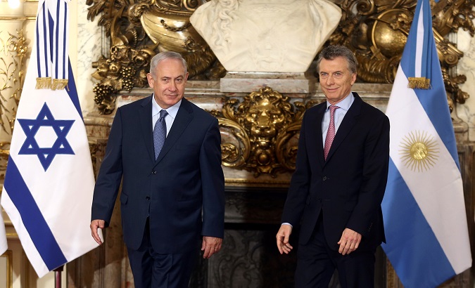 Israeli Prime Minister Netanyahu and Argentina's President Macri arrive for a ceremony at the Casa Rosada Presidential Palace in Buenos Aires