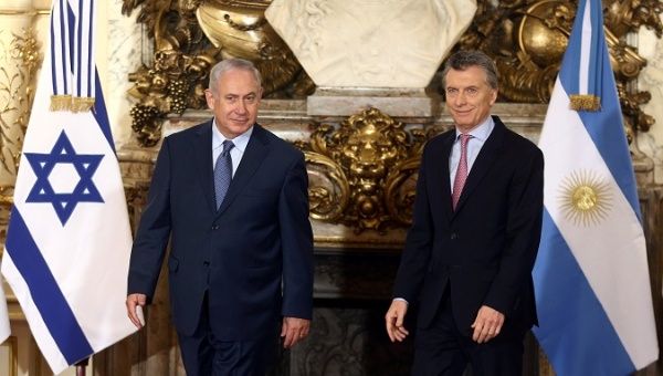 Israeli Prime Minister Netanyahu and Argentina's President Macri arrive for a ceremony at the Casa Rosada Presidential Palace in Buenos Aires