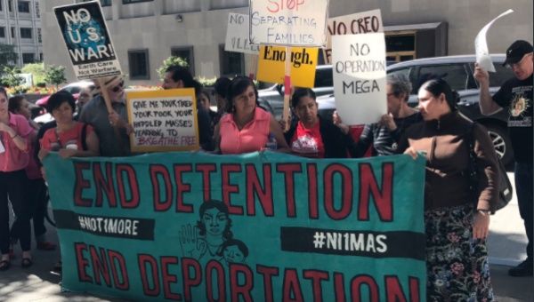 Members of the Detention Watch Network, Mijente, and NWDC Resistance hold an action at ICE Enforcement and Removal Operations field office in Seattle, Washington, Sept. 12, 2017.