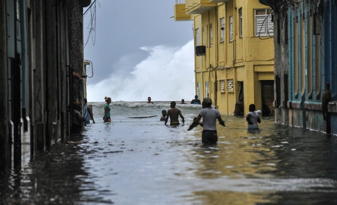 Residents wade through a flooded street in Havana, on September 10, 2017.