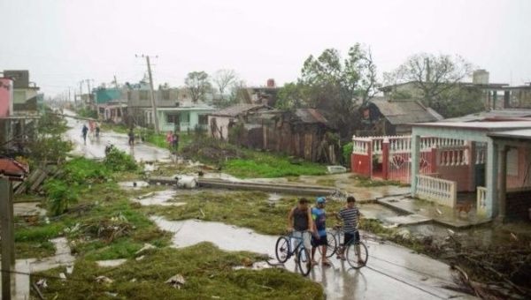 People walk on a damaged street after the passage of Hurricane Irma in Caibarien, Cuba.