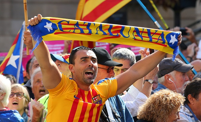 A man holds up a scarf which reads 'Catalonia' at the rally in Barcelona, Spain, September 16, 2017.