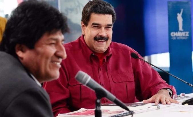 President Nicolas Maduro listens to Bolivian President Evo Morales speak during the solidarity summit.