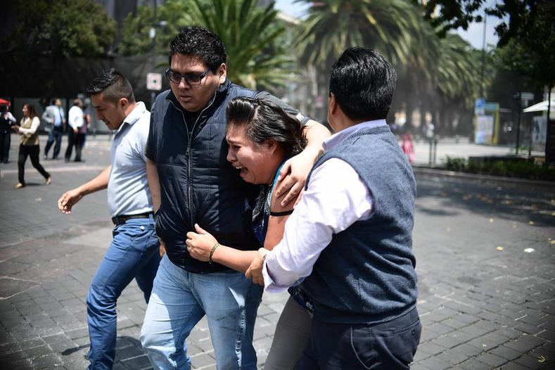 People react after an earthquake hit in Mexico City, Mexico September 19, 2017.
