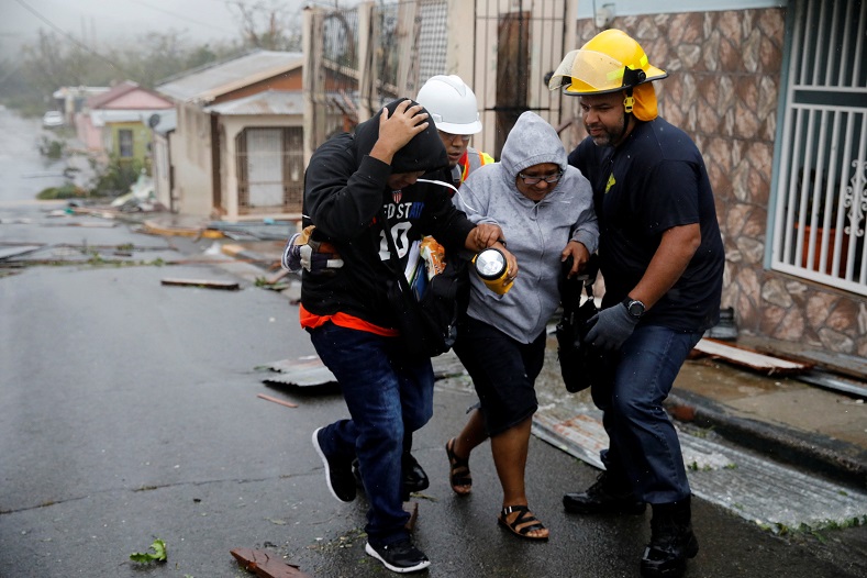 Rescue workers help people after Maria hit Guayama, Puerto Rico.
