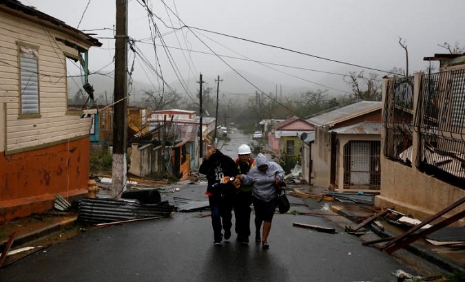 Rescue workers help people after the area was hit by Hurricane Maria in Guayama, Puerto Rico.