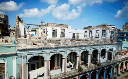 A man works at the terrace of a building in which the facade collapsed during the passage of Hurricane Irma in downtown Havana, Cuba.