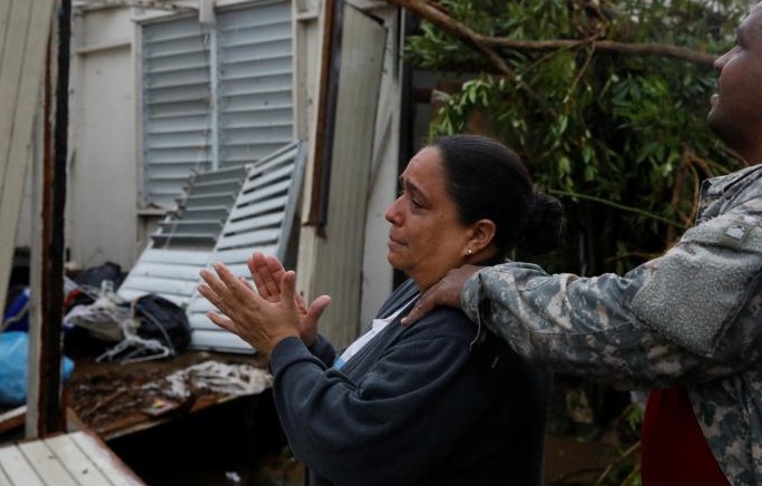 A woman surveys the damage at her mother's house in Guayama, Puerto Rico
