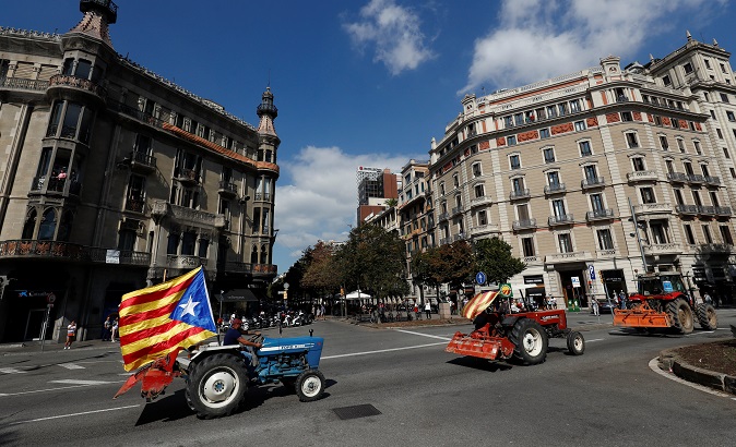 Farmers drive their tractors through Barcelona streets in support of Catalonia's independence vote.