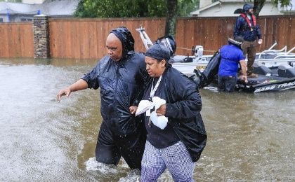 Families were forced to wade through the floodwaters to find shelter, Houston, U.S., August 28, 2017.