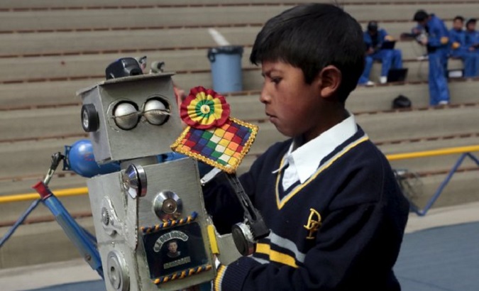 A Bolivian boy shows his work in a robotics fair in La Paz.