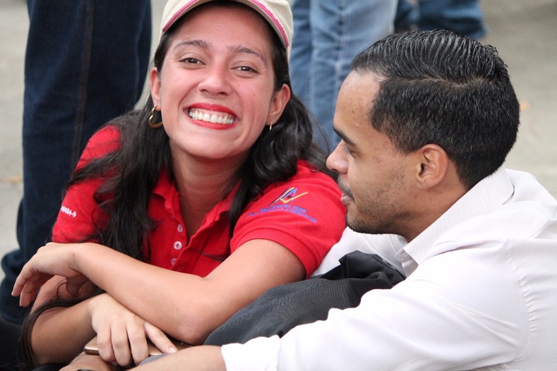 A woman smiles while attending Venezuela's Feminist Socialism march.