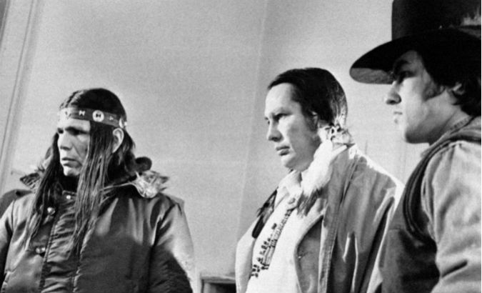 AIM leaders Dennis Banks (L) and Russell Means (C) attend a meeting in 1973, as about 200 Indigenous people occupy Wounded Knee in South Dakota.