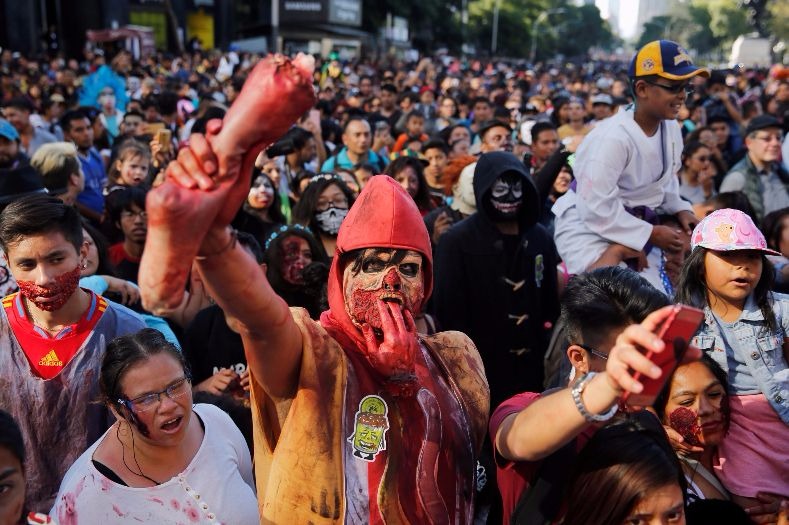 A man holds a fake foot at the Zombie Walk in Mexico City.