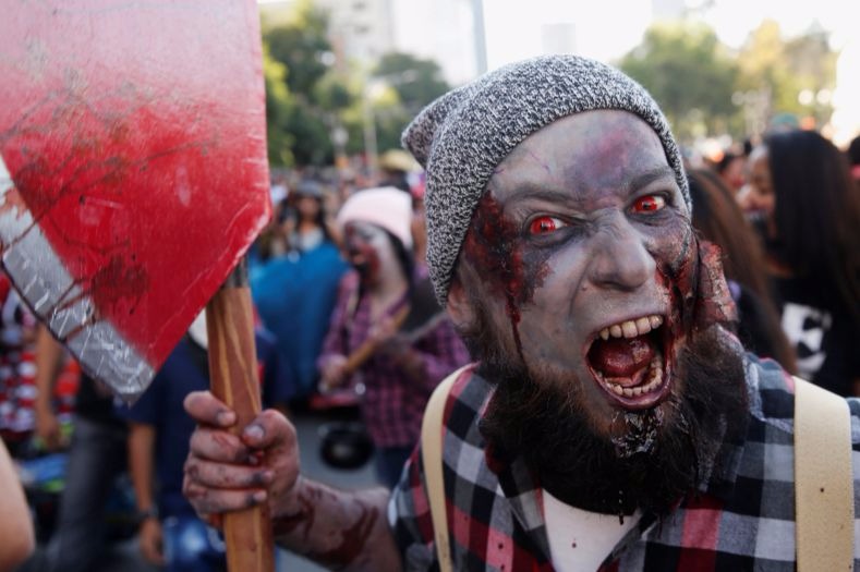 A man carries a hatchet at the Zombie Walk in Mexico City.