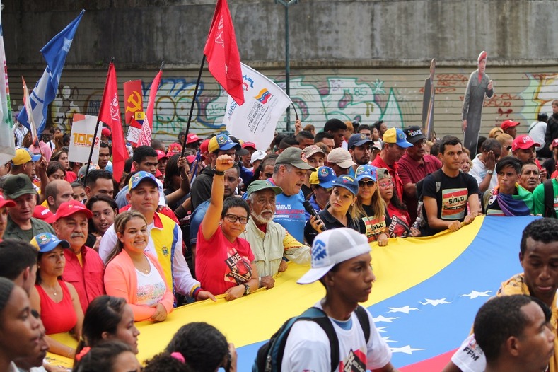 Venezuelans march to the Miraflores Presidential Palace celebrating the influence of the Russian revolution in Latin America.