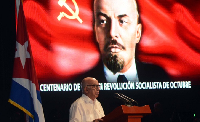 José Ramón Macado Ventura, the Second Secretary of the Cuban Communist Party Central Committee speaks in front of a picture of Bolshevik leader Vladimir Lenin.
