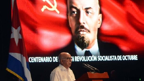 José Ramón Macado Ventura, the Second Secretary of the Cuban Communist Party Central Committee speaks in front of a picture of Bolshevik leader Vladimir Lenin.