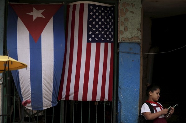 A child stands in front of a Havana house adorned with U.S. and Cuba flags as relations between the two countries sink to a new low.