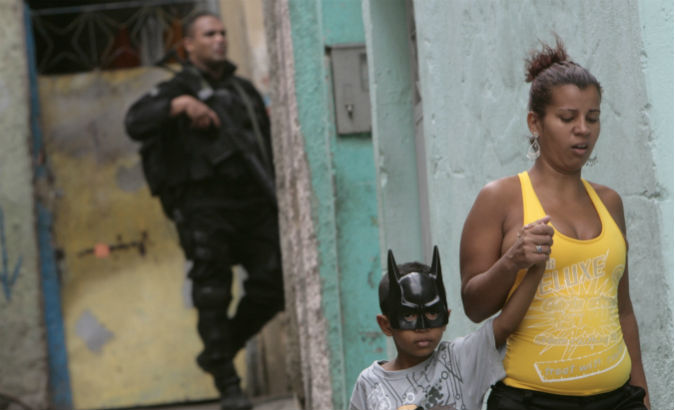A Brazilian security official patrols a working-class neighborhood.