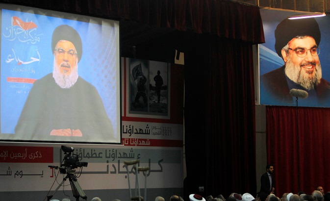 Sayyed Hassan Nasrallah the leader of Hezbollah is seen on a video screen as he addresses his supporters in Beirut, Lebanon, Nov. 10, 2017.