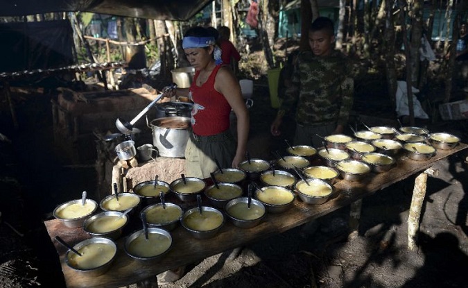 A member of the FARC serves soup for lunch at their camp in El Diamante, Colombia, last year.
