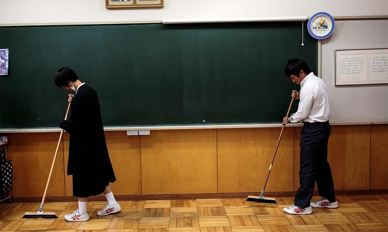 Students clean the classroom after an exam at Tokyo Korean high school.