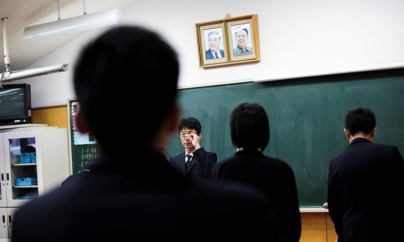 A teacher gestures after giving an exam to his students at Tokyo Korean high school.