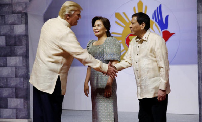 U.S. President Trump shakes hands with Philippines President Duterte as he arrives for the gala dinner in Manila, Philippines, Nov. 12, 2017.