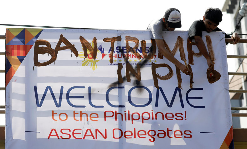 Anti-Trump protesters deface an ASEAN poster as they oppose the planned visit of U.S. President Donald Trump who is attending the ASEAN leaders summit in Manila, Philippines November 7, 2017.