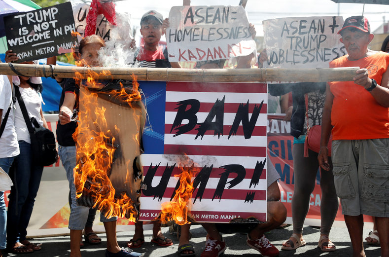 Protesters burn a mock U.S. flag to protest the visit of U.S. President Donald Trump to attend the ASEAN leaders summit in Manila, Philippines, November 7, 2017.