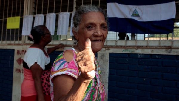 A woman shows her ink-stained thumb after voting in the municipal elections at a polling station in Managua, Nicaragua November 5, 2017.