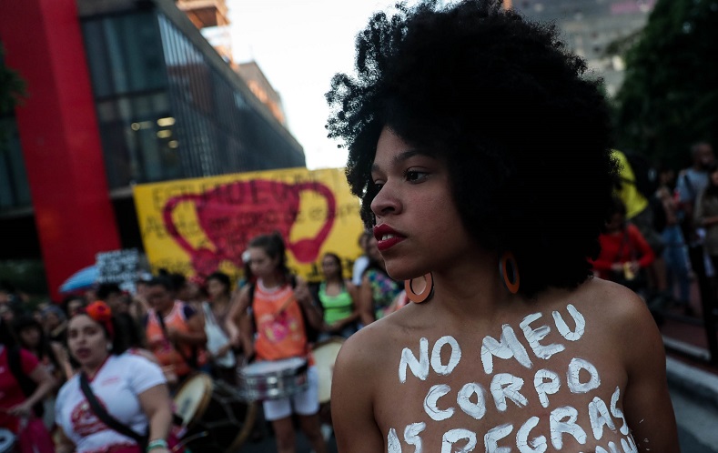 Women wrote messages on their bodies and took signs saying 