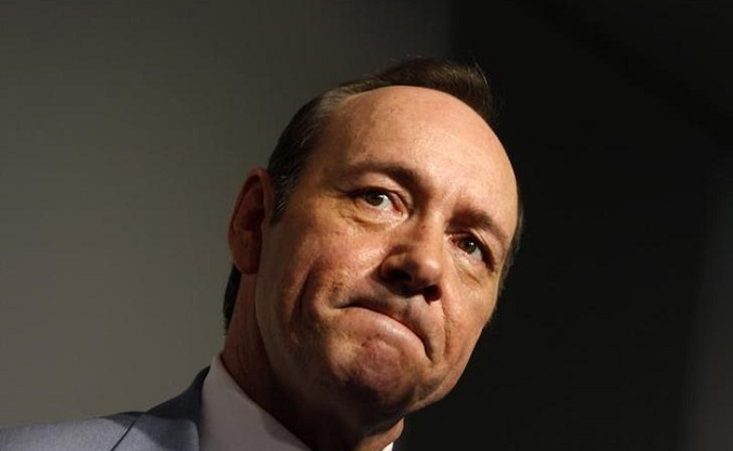 Actor Kevin Spacey speaks to a reporter as he arrives during the premiere of 
