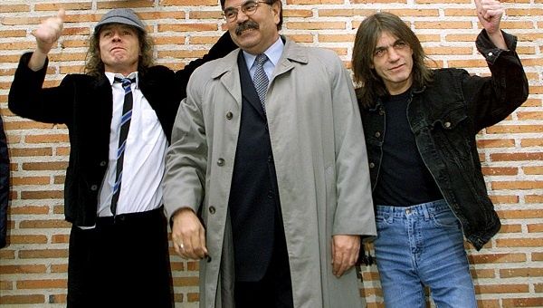 Angus and Malcolm (R) Young, founder members of AC/DC, flank the mayor of Leganes in Madrid following the inauguration of a new street with the group's name in 2000.