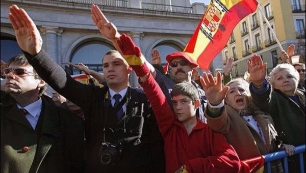 Supporters of Spain's late dictator Francisco Franco give fascist salutes.