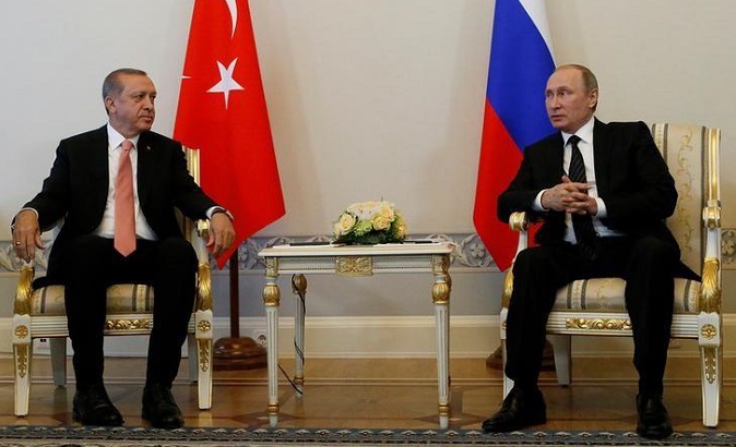 Russian President Vladimir Putin speaks to Turkish President Tayyip Erdogan during their meeting in St. Petersburg, Russia, August 9, 2016.