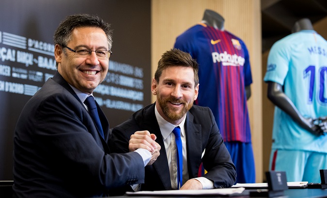 Messi poses with FC Barcelona president Josep Maria Bartomeu during the signing of his new contract in Barcelona