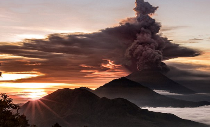 Mount Agung volcano is seen spewing smoke and ash in Bali on Sunday.