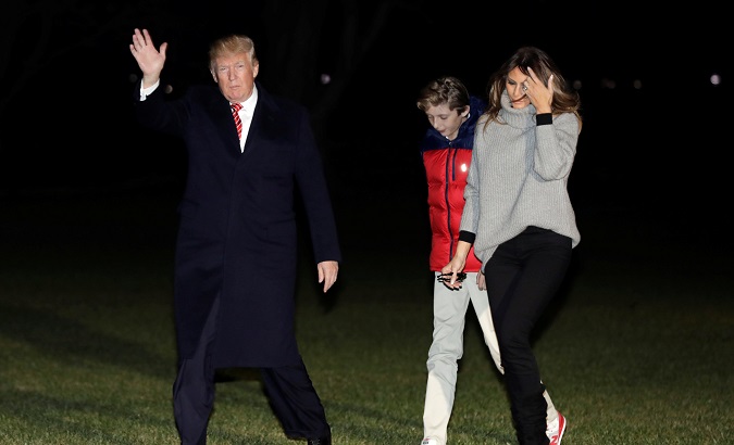 U.S. President Donald Trump waves as he walk with First Lady Melania Trump and their son Barron on the South Lawn of the White House upon their return to Washington, U.S., after a Thanksgiving vacation in Florida, November 26, 2017