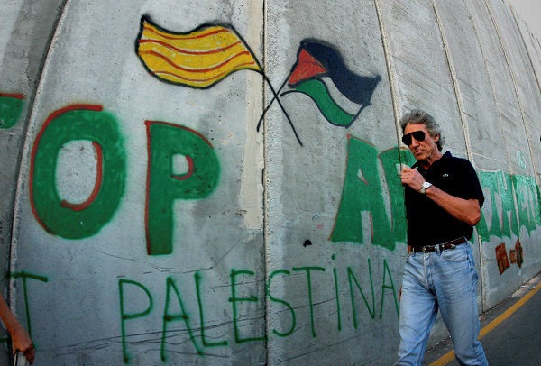 British rock star Roger Waters, of Pink Floyd, walks along the controversial Israeli barrier in the West Bank city of Bethlehem, 2006.