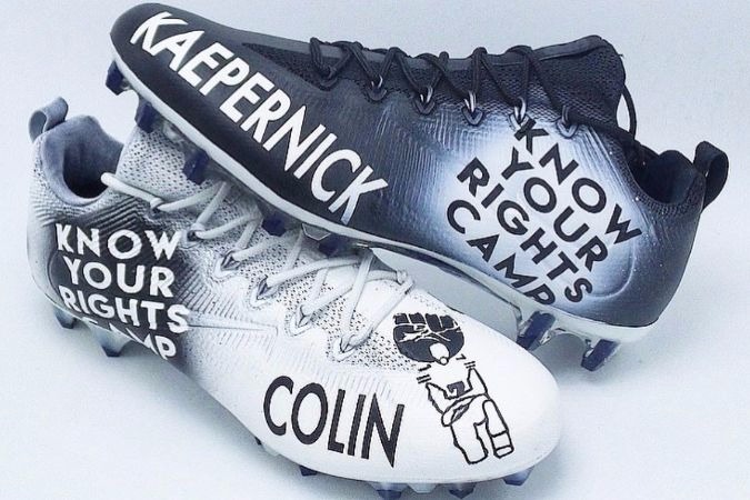 Cleats with Kaepernick's Know Your Rights Camp campaign logo.