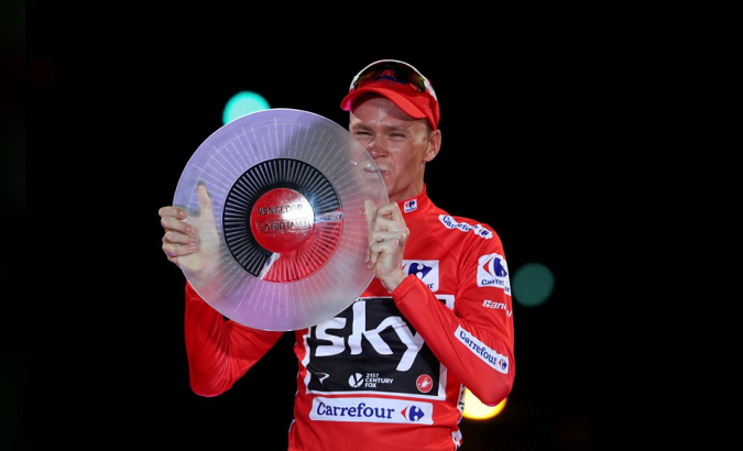 Team Sky rider Chris Froome of Britain celebrates on the podium after winning the Vuelta Tour of Spain.