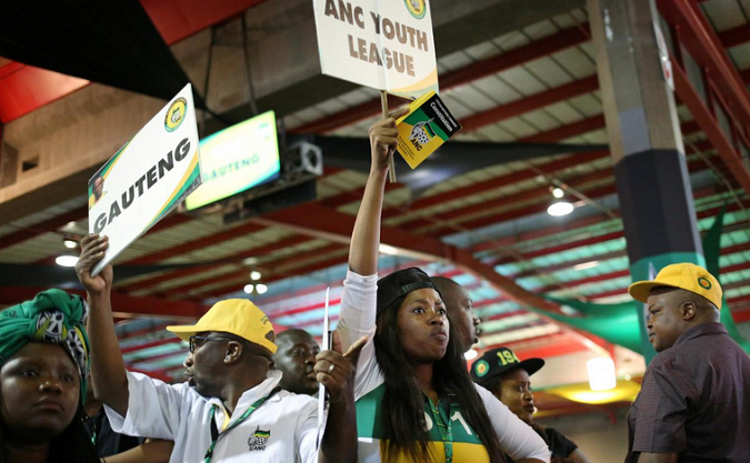 ANC members hold placards at the 54th National Conference of the ruling African National Congress (ANC) at the Nasrec Expo Centre in Johannesburg, South Africa December 17, 2017.