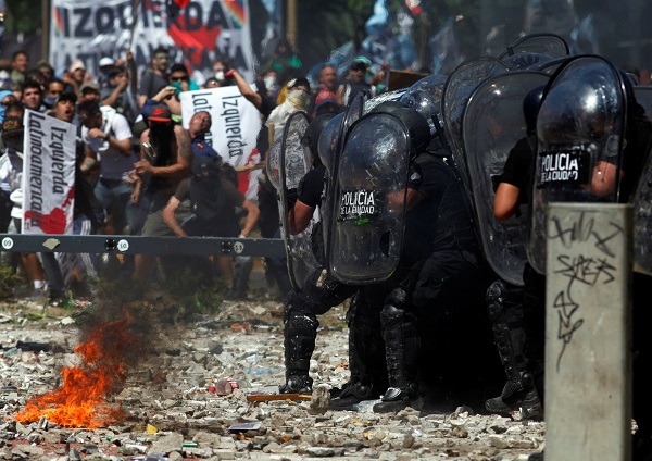 Police and demonstrators clash as lawmakers pass a pension reform measure in Buenos Aires.