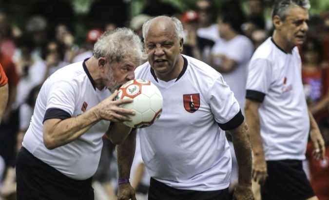 Former Brazilian President Luiz Inacio 'Lula' da Silva (L) and singer Chico Buarque on the pitch.